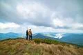 The happy man and a woman standing on the top of a mountain Photo