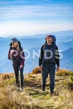 The happy man and a woman walking on the mountain Stock Photos