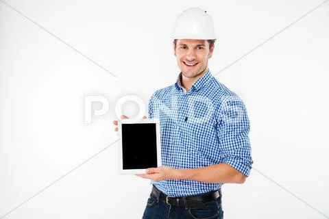 Happy man architect in building helmet holding blank screen tablet Stock Photos