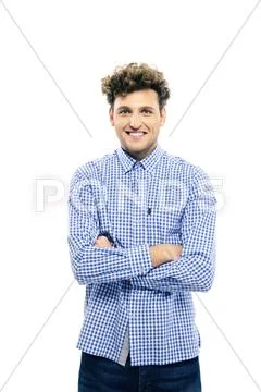 Happy man with arms folded standing isolated on a white background Stock Photos