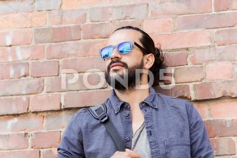 Happy man with backpack standing at city street Stock Photos