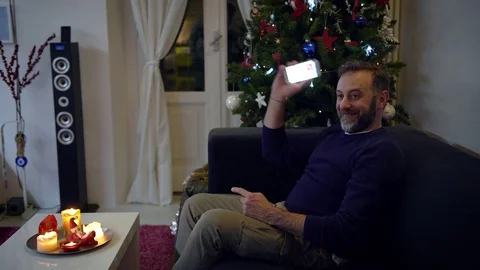 Happy man with a beard receiving some very good news on his mobile phone with Stock-Footage 79539739