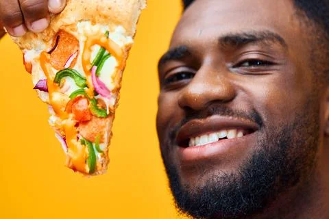 Happy man black guy delivery fast smile isolated food overeating pizza food Stock Photos