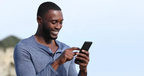 Happy man with black skin using smart phone Stock Footage 167911884