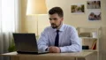 Happy man in business suit sighs with relief after successful interview online HD Footage