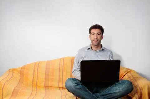 Happy man on the couch Stock Photos