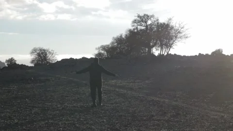 Happy Man Dancing Alone in Rural Morocco Countryside Dramatic Backlight Stock-Footage 332772441