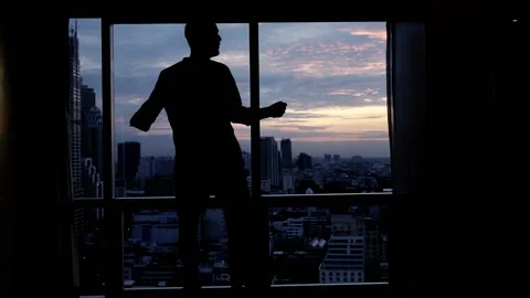 Happy man dancing close to the window, super slow motion Stock Footage 106559607