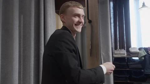 Happy Man Dancing in a New Suit in Fitting Room Stock Footage 330514749