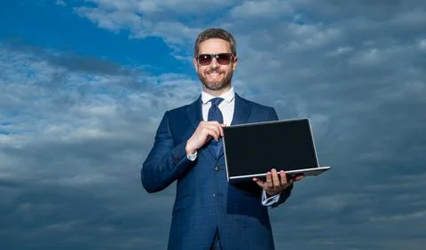 Happy man developer showing open laptop. Successful desktop developer. Software Stockfoto's