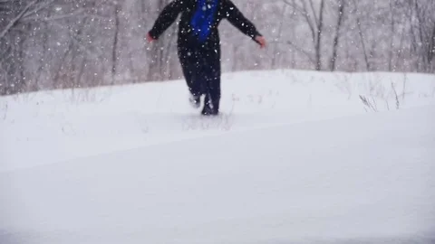 Happy Man Dives into the Deep Snow and Having Fun in the Winter Pine Forest Stock Footage