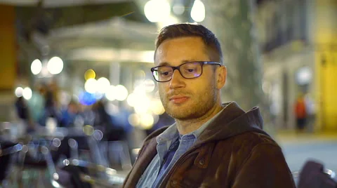 Happy man drinking beer in the cafe at night, steadycam shot Stock-Footage 62880421