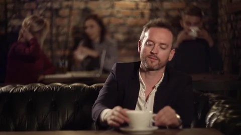 Happy man drinking coffee and relaxing in cafe Video stock 69963918