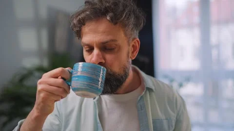 Happy man drinking coffee at relaxed home environment closeup. Stock Footage 346727972