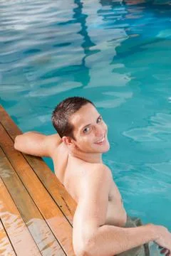 Happy man in the edge of the pool Stock Photos