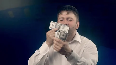 Happy man feels delight looking through a roll of bills Stock-Footage 68566095