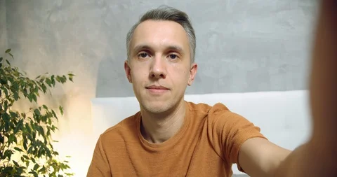 Happy man gesturing showing a thumbs up talking enjoying online communication Stock Footage 129099829