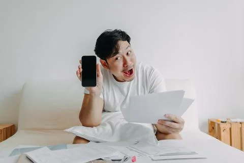 Happy man get application solution to solve finance documents problem. Stock Photos