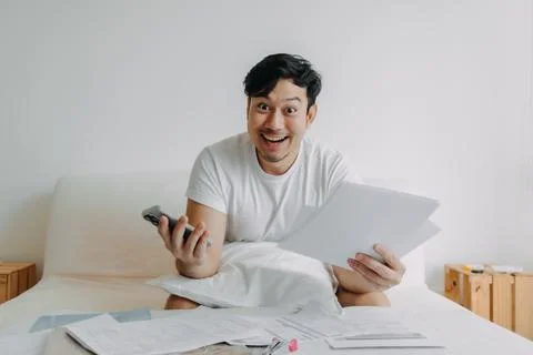 Happy man get application solution to solve finance documents problem. Stock Photos