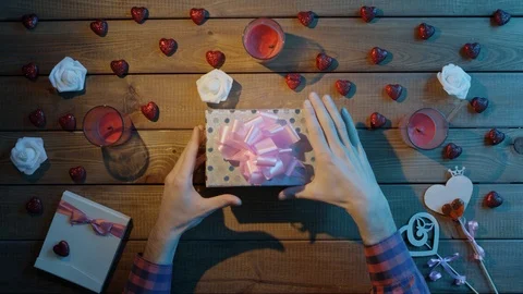 Happy man gets soft bunny as valentine day present, top view Stock Footage 87972567