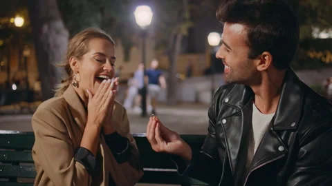 Happy man giving ring making proposal in night park closeup. Excited girl hug Stock Footage 262489156