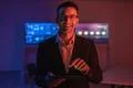The happy man in glasses working with a tablet in the dark room Photo
