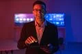 The happy man in glasses working with a tablet in the dark room Photo