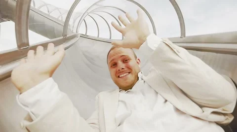 Happy man having fun sliding down on slide in slow motion. carefree happiness Stock Footage 42947904