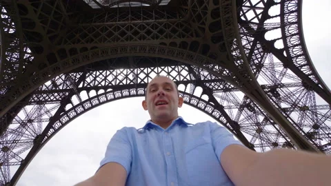 Happy man having fun under the Eiffel Tower Paris in 4k slow motion Video stock 88643264