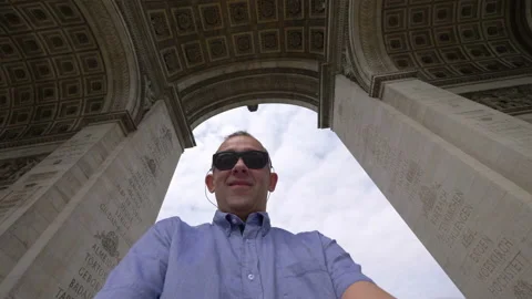 Happy man having fun under Arc de Triomphe in Paris in 4k slow motion 60fps Stock Footage 119835541