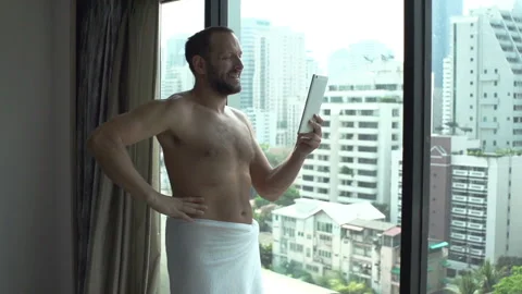 Happy man having a video call on tablet in the morning, slow motion 240fps Stock Footage 88540506