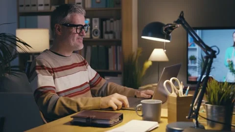 Happy man having a video call on his laptop Stock Footage 306126521