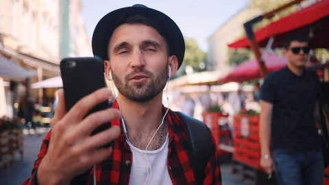 Happy man holding a map looking at her speak on phone looking around smile young Stock Footage 92073148