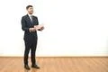 The happy man holding papers on the white wall background Photo
