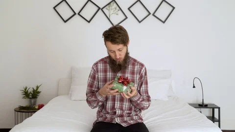 Happy man holding a present in an authentic room. Stock Footage 102655147
