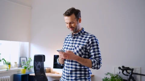 Happy man at home typing message on smartphone Stock Footage 126826119