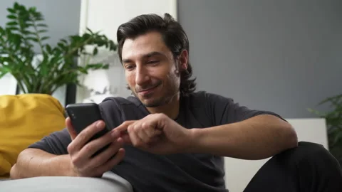 Happy man at home using mobile phone Stock Footage 149258787