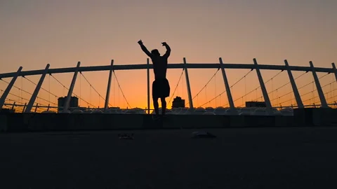 Happy man jumping during the sunset and having fun. Slow motion. Stock Footage 92089890