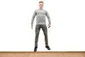 The happy man jumping on the white wall background Photo