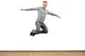 The happy man jumping on the white wall background Photo