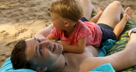 Happy man with kid on beach Stock Footage 103240069