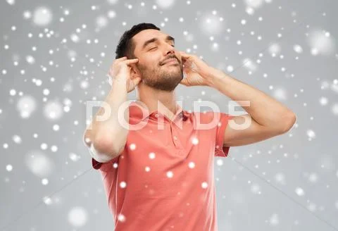 Happy Man Listening To Music Over Snow Background
