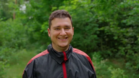 Happy man looking at camera smile laughing at forest Stock Footage 158145371