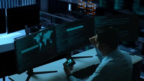 Happy Man Looking At Code On Mobile Phone While Write Code With Multiple Stock Footage 255847344