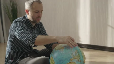 Happy man looking at globe, exploring new countries for travel Stock-Footage 157603560