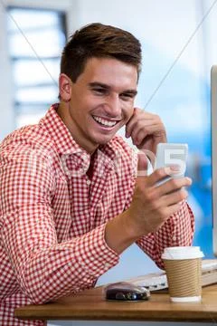 Happy Man Looking At Mobile Phone