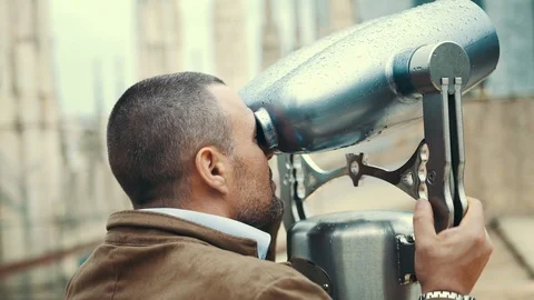 Happy man looking through a viewing scope Stock Footage 108601279