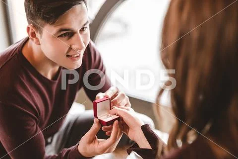 The happy man makes a proposal to his girlfriend in the restaurant Stock Photos