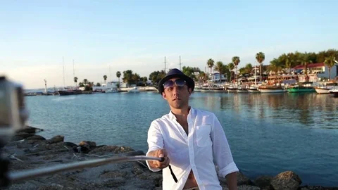 Happy man makes a selfie in front of the marine bay, Side, Turkey Stock-Footage 71102401