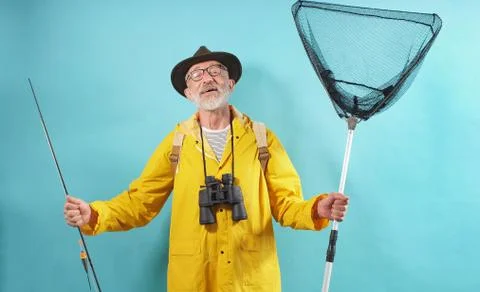 A happy man, an old man with a beard in a hat and glasses, dressed in a bright Stock Photos